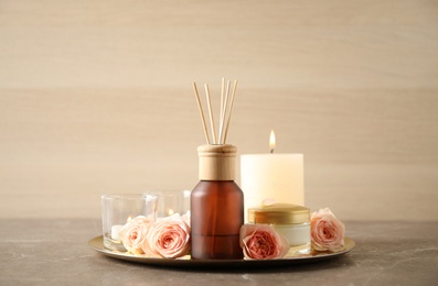 Photo of Spa composition with aroma oil and roses on grey table