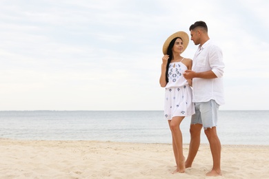 Lovely couple spending time together on beach. Space for text