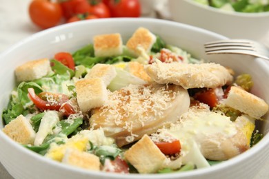 Photo of Delicious Caesar salad in bowl, closeup view