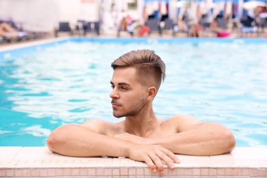 Young man in pool on sunny day