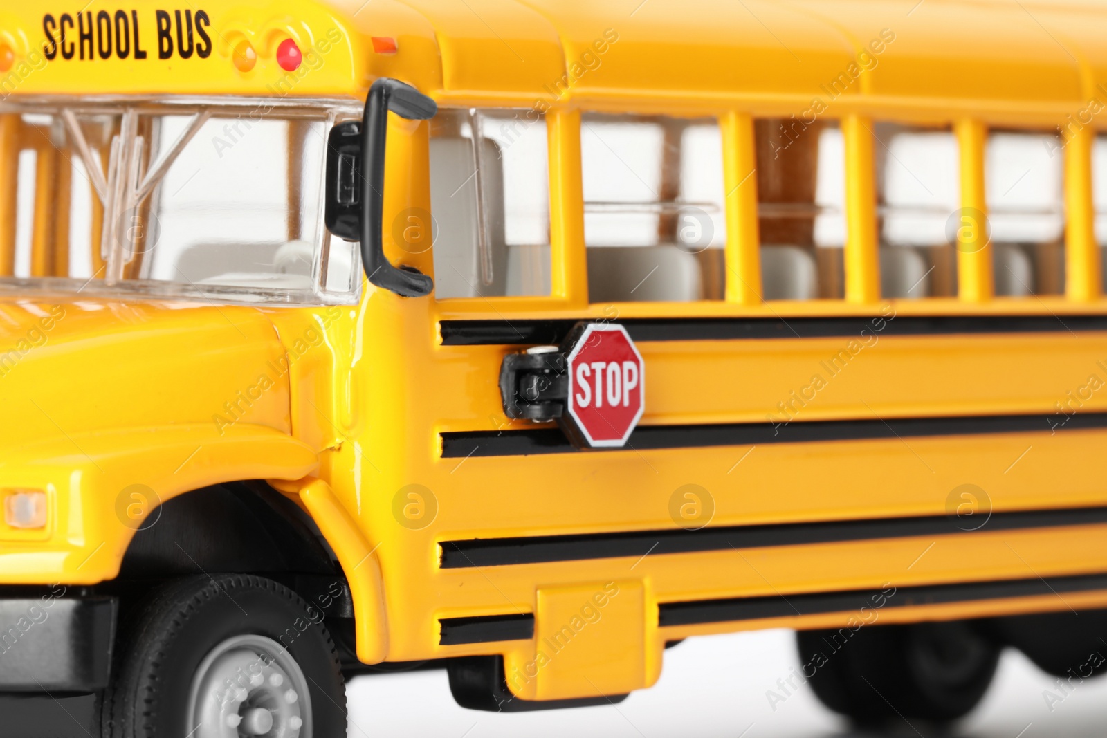 Photo of Yellow school bus on white background, closeup. Transport for students