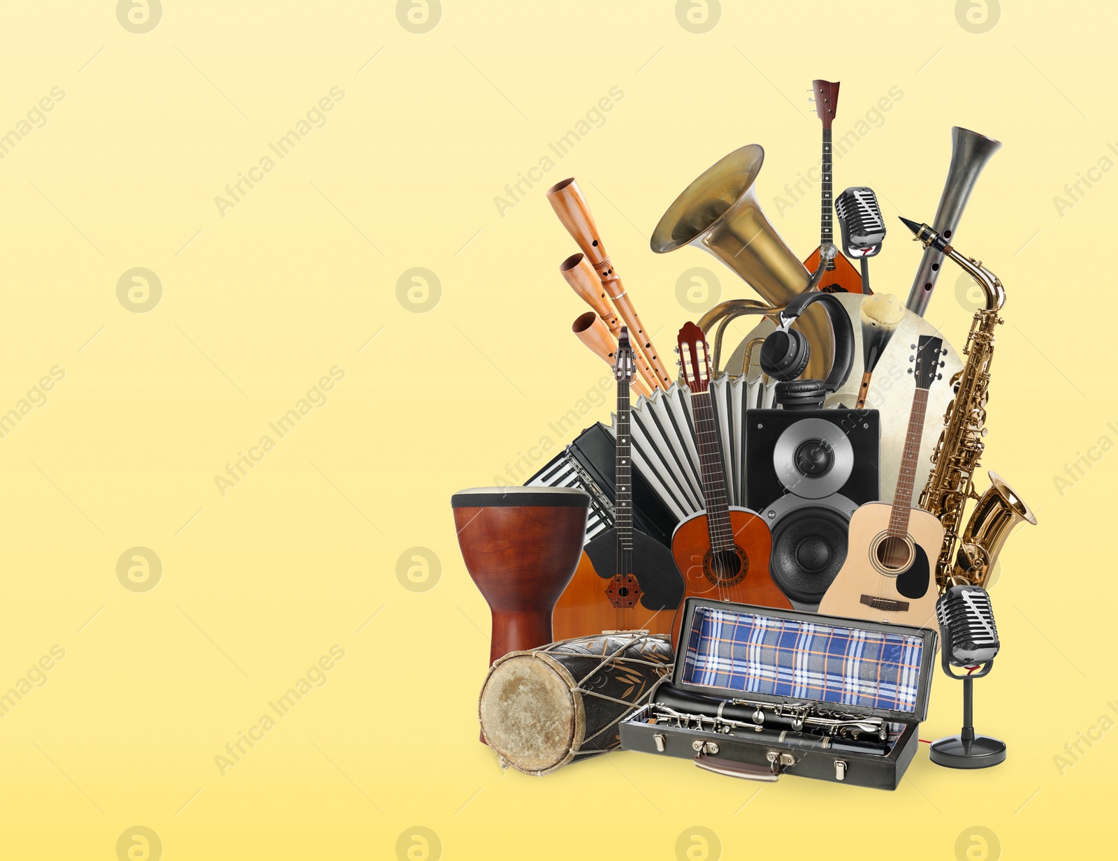 Image of Group of different musical instruments on yellow background, space for text