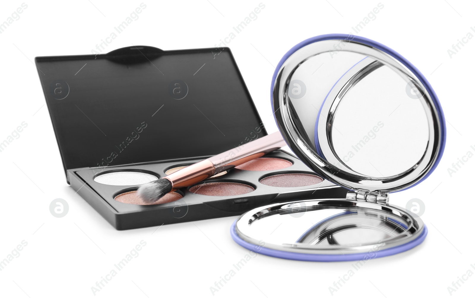 Photo of Stylish cosmetic pocket mirror and eyeshadows on white background