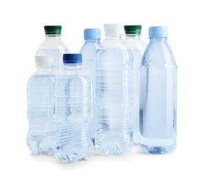 Set of different plastic bottles with water on white background