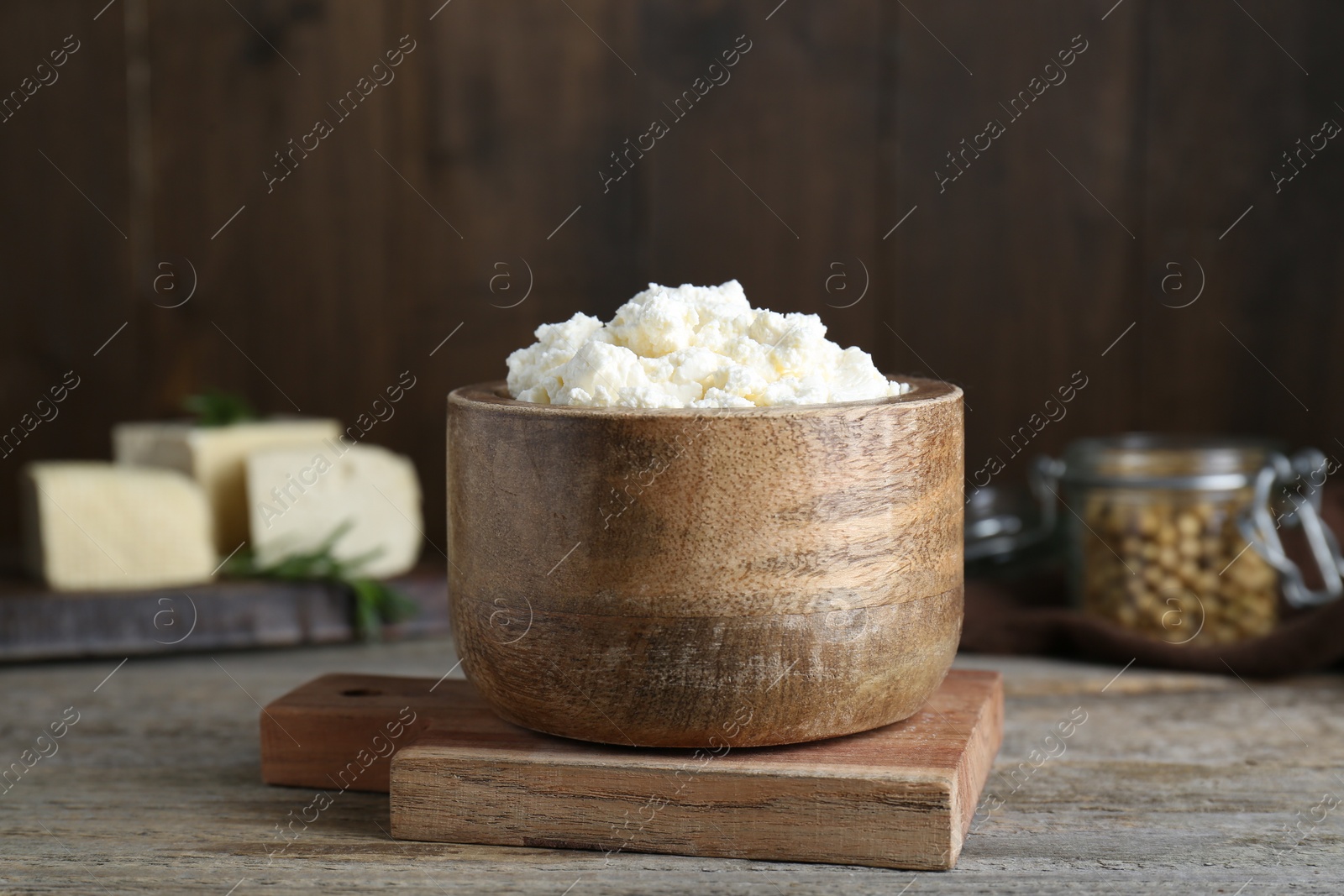 Photo of Delicious tofu cream cheese in bowl on wooden table