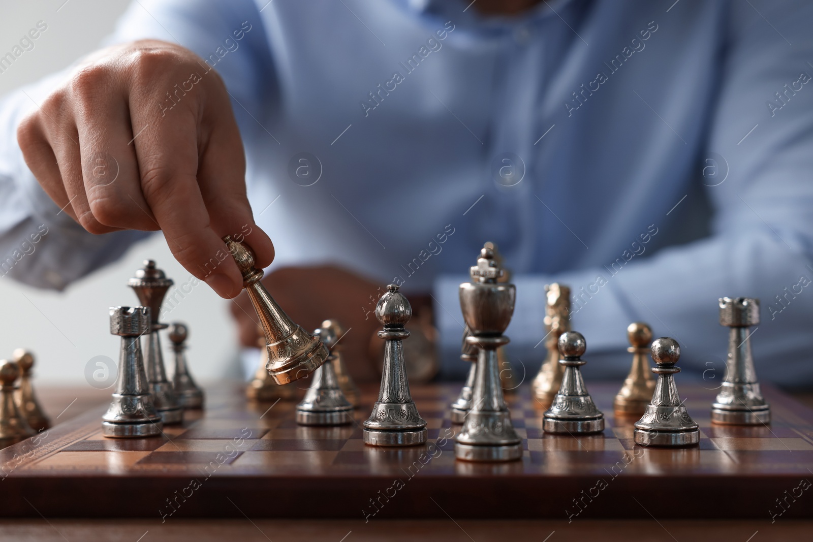 Photo of Man playing chess during tournament at chessboard, closeup