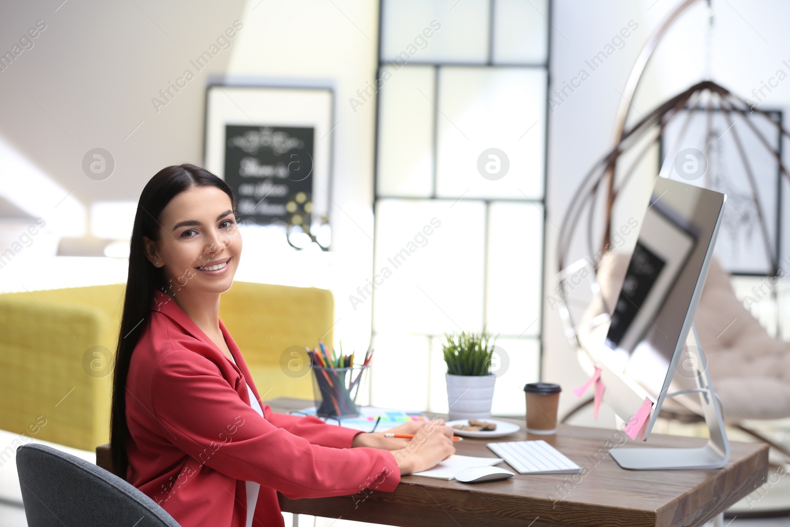 Photo of Female designer working at desk in office