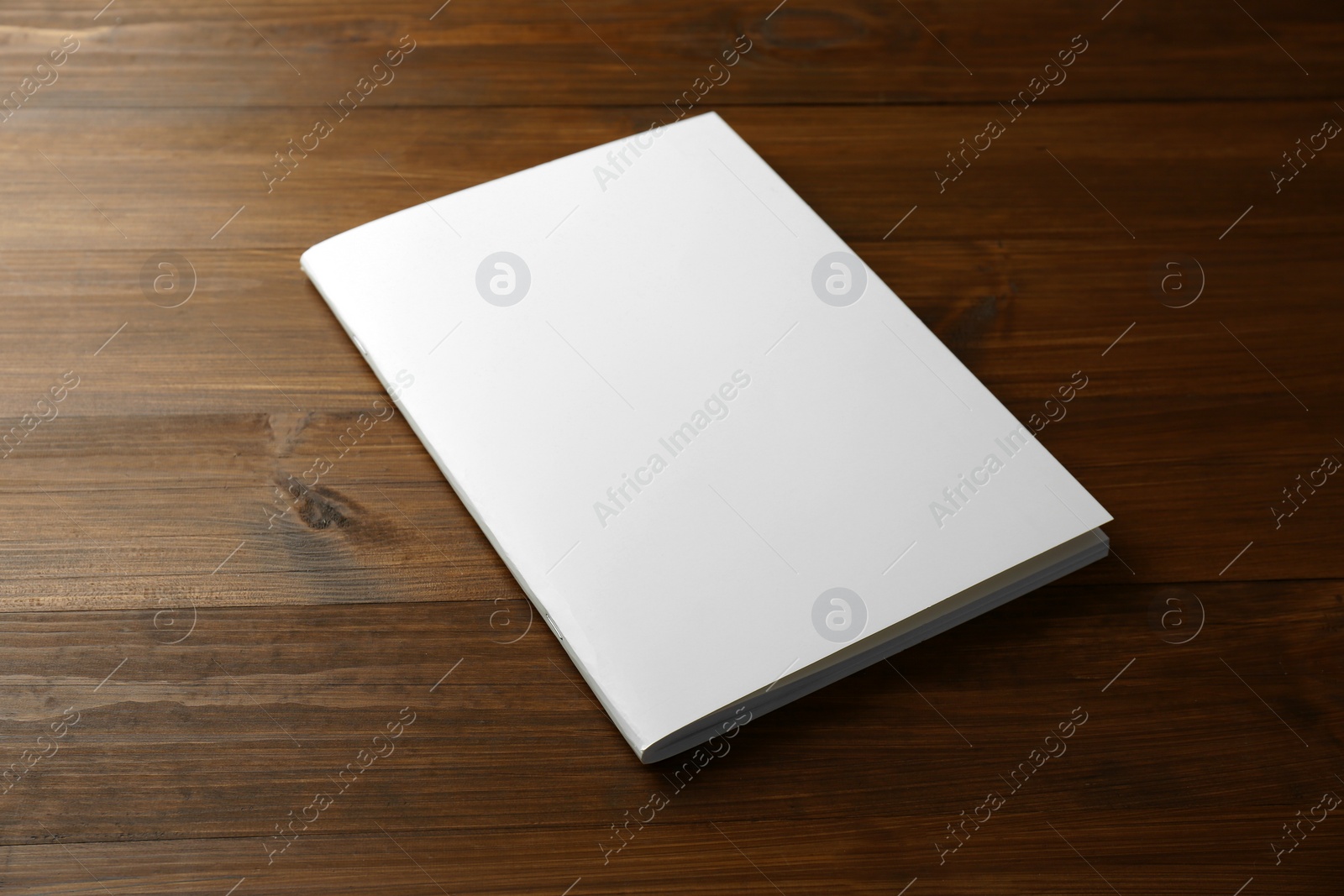 Photo of Blank paper brochure on wooden table. Mockup for design