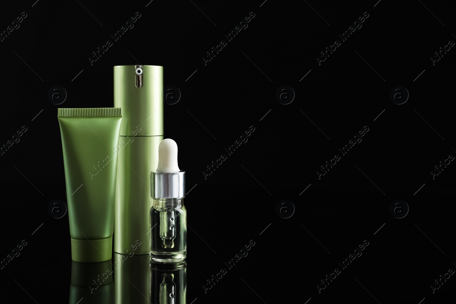 Photo of Set of cosmetic products on black background, space for text