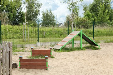 Photo of Wooden rover jump over and king of hill on animal training area outdoors