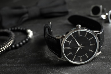 Photo of Luxury wrist watch on black background, closeup