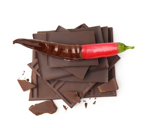 Photo of Red hot chili pepper and dark chocolate isolated on white, above view