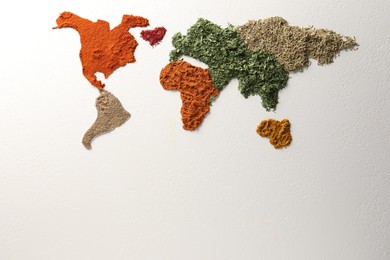 World map of different spices on white textured table, flat lay. Space for text