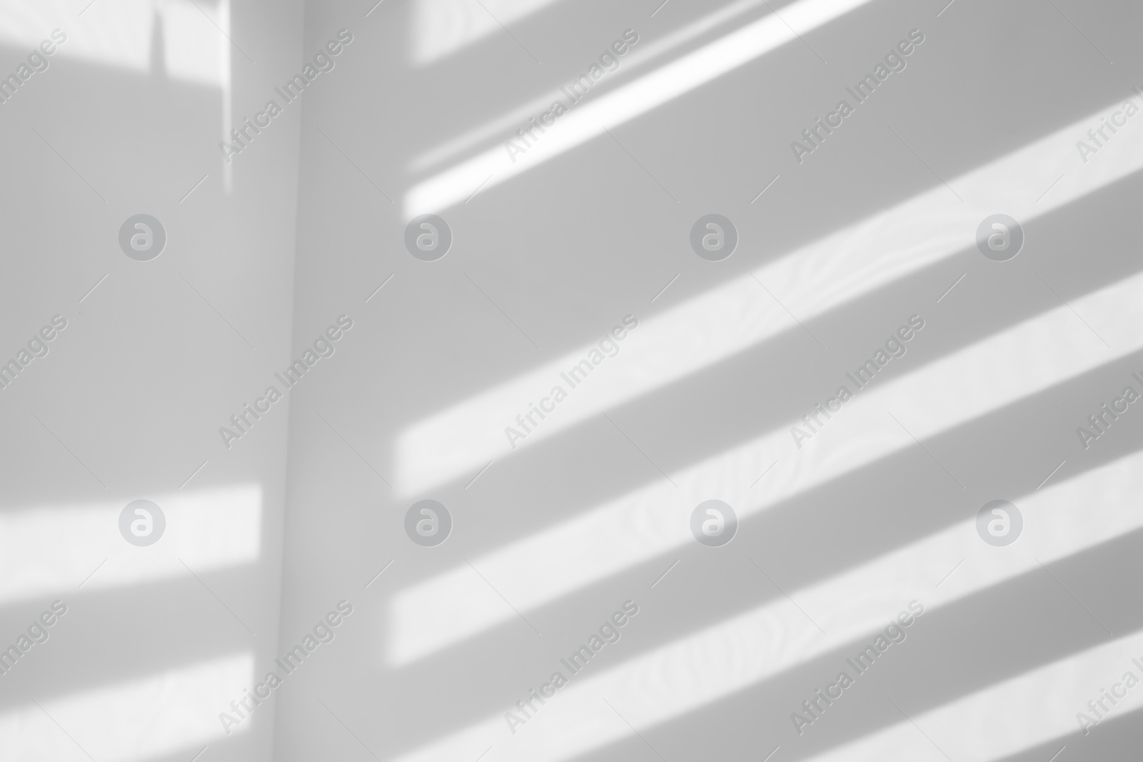 Photo of Lines made of light and shadows on white wall