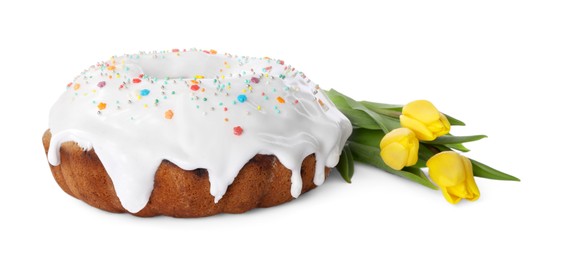 Photo of Easter cake with sprinkles and yellow tulips isolated on white