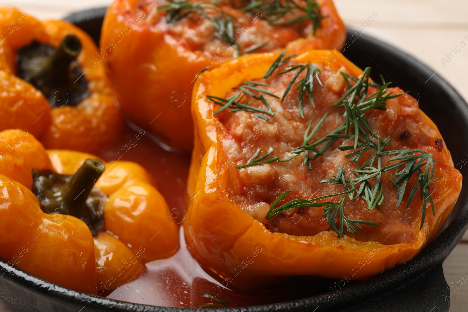 Photo of Tasty stuffed peppers in pan on table, closeup