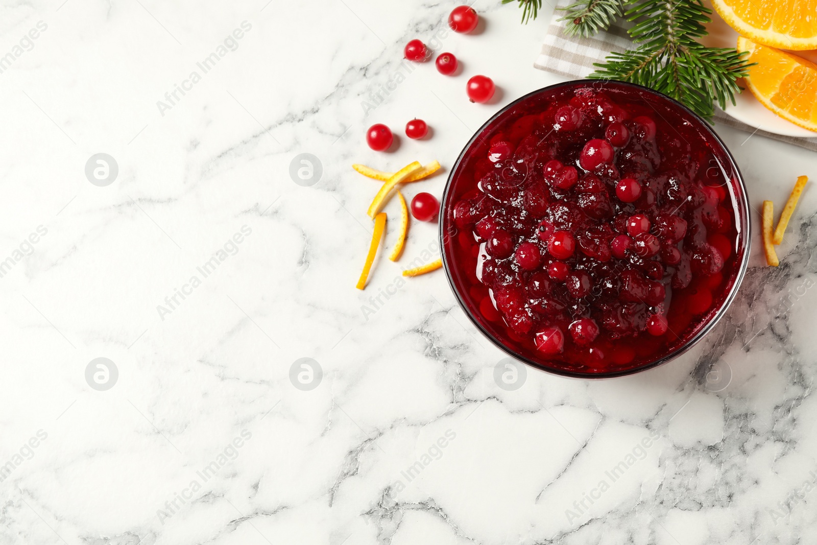 Photo of Flat lay composition with cranberry sauce on white marble table. Space for text