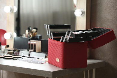 Case with makeup products on dressing table