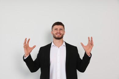 Photo of Emotional young man on white background. Aggression concept