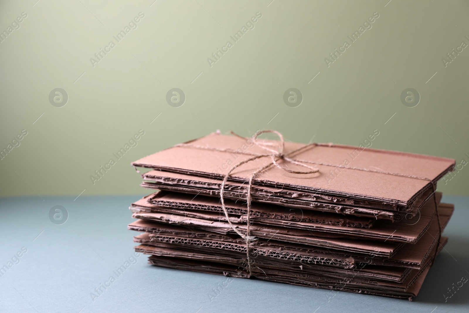 Photo of Stack of waste paper on grey table, space for text