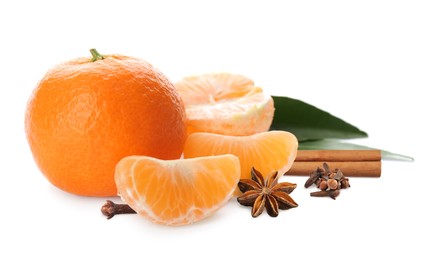 Fresh ripe tangerines, cloves, anises and cinnamon on white background