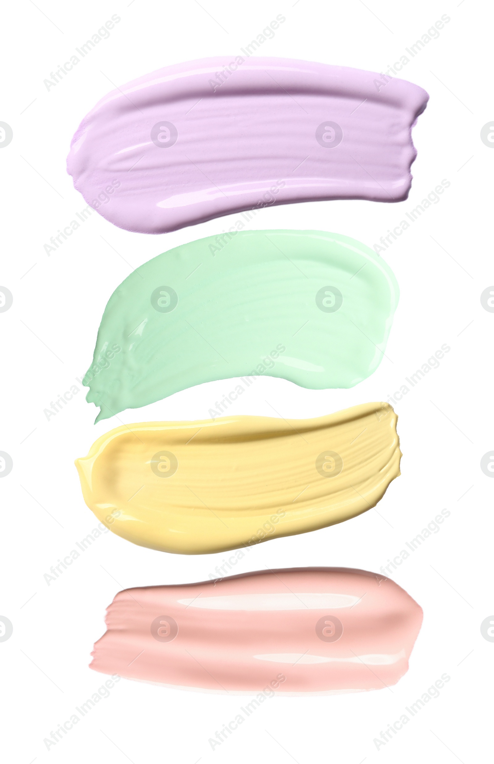 Image of Set with strokes of color correcting concealers on white background, top view