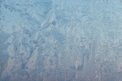 Beautiful frosty window as background, closeup. Winter morning