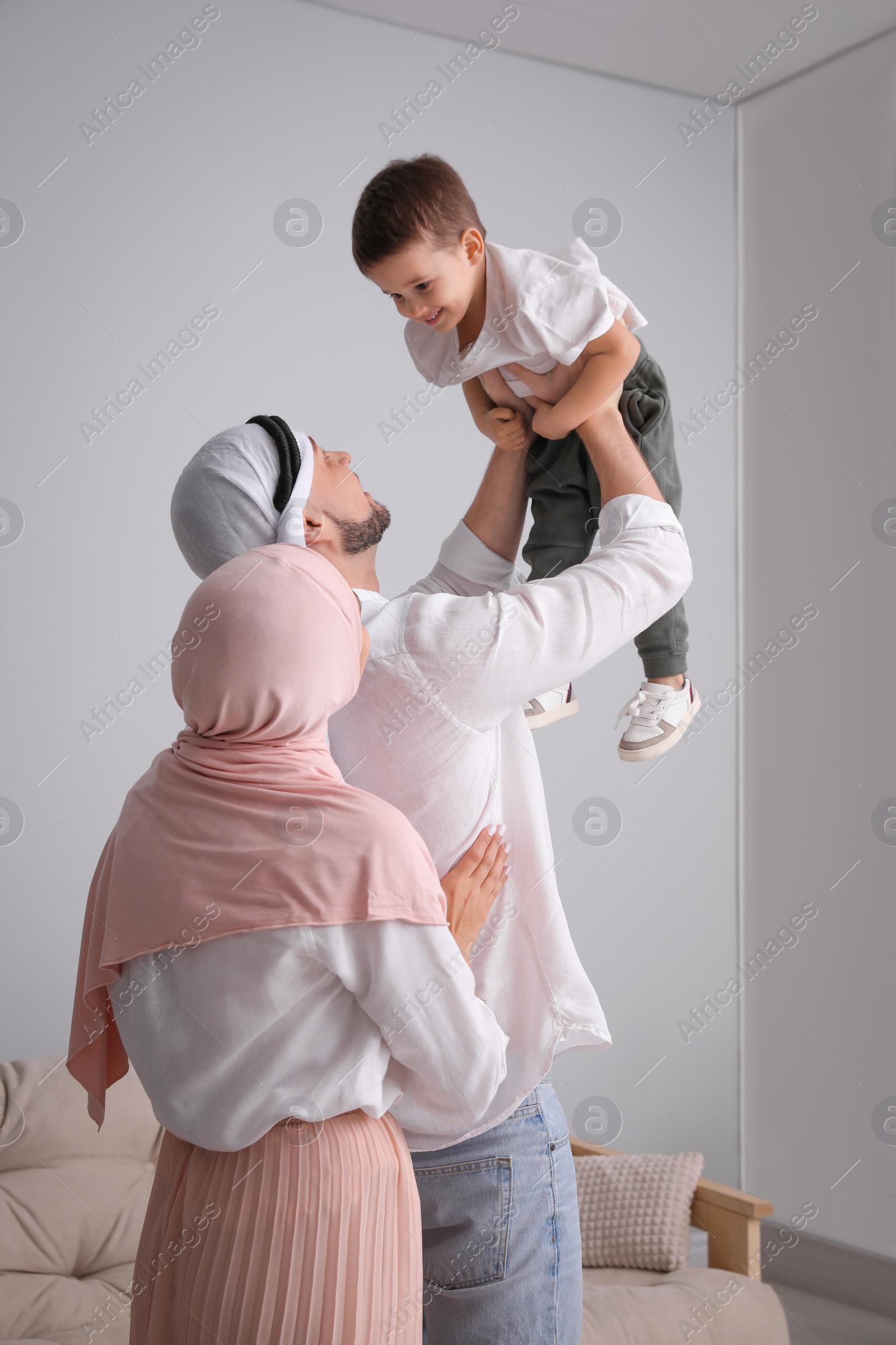 Photo of Happy Muslim family spending time together at home