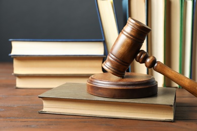 Wooden gavel and books on table. Law concept