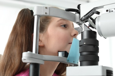 Photo of Little girl visiting ophthalmologist in clinic