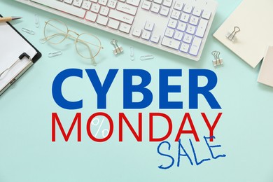 Cyber Monday Sale. Modern keyboard and stationery on turquoise background, flat lay 