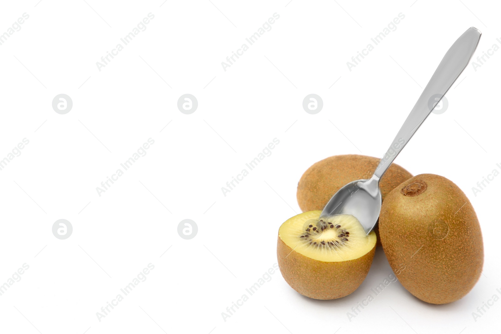 Photo of Fresh ripe yellow kiwis with spoon on white background