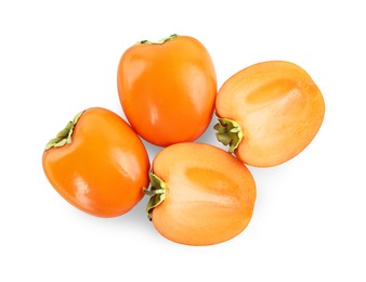 Photo of Whole and cut persimmon fruits isolated on white, top view