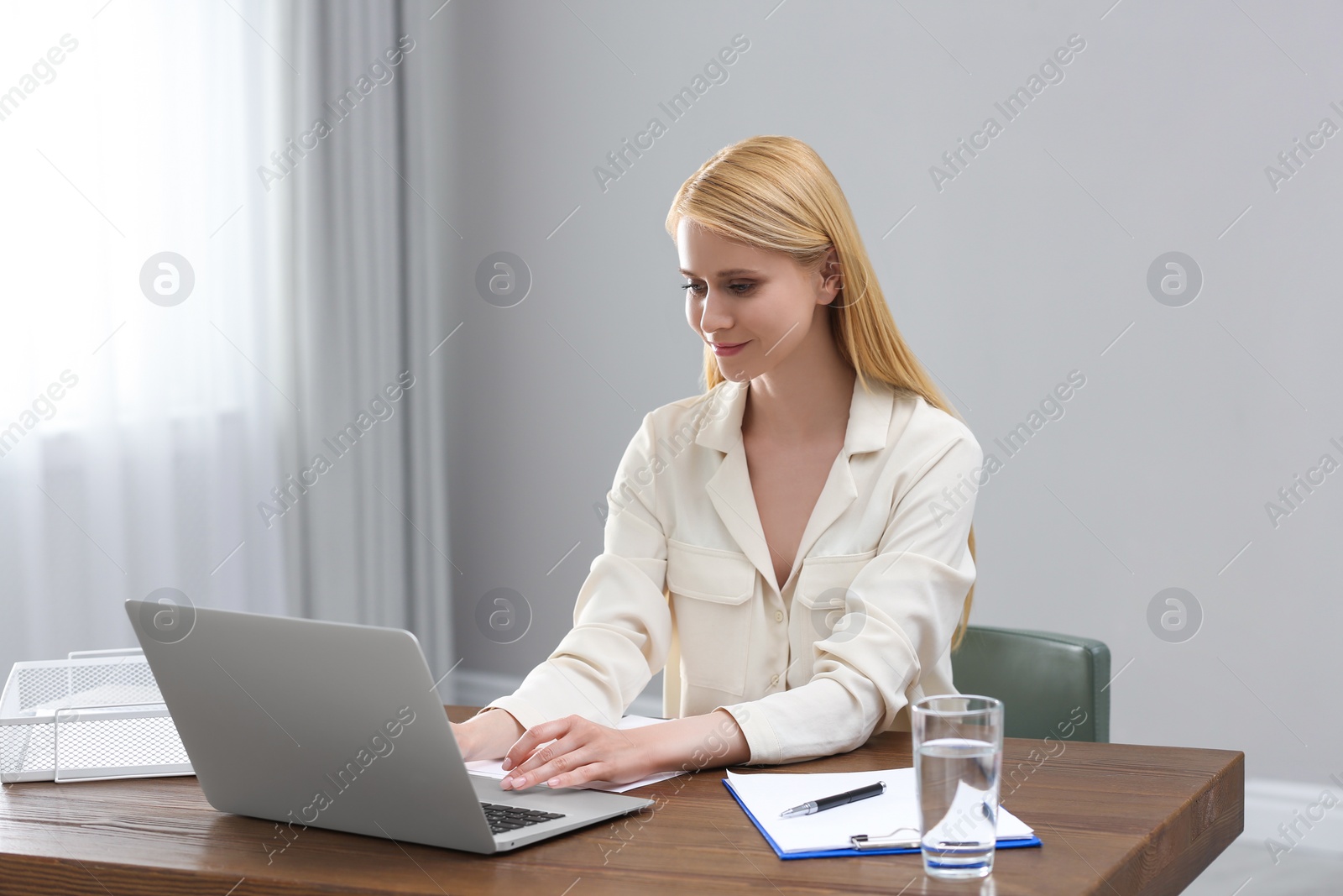 Photo of Professional lawyer working on laptop at table in office