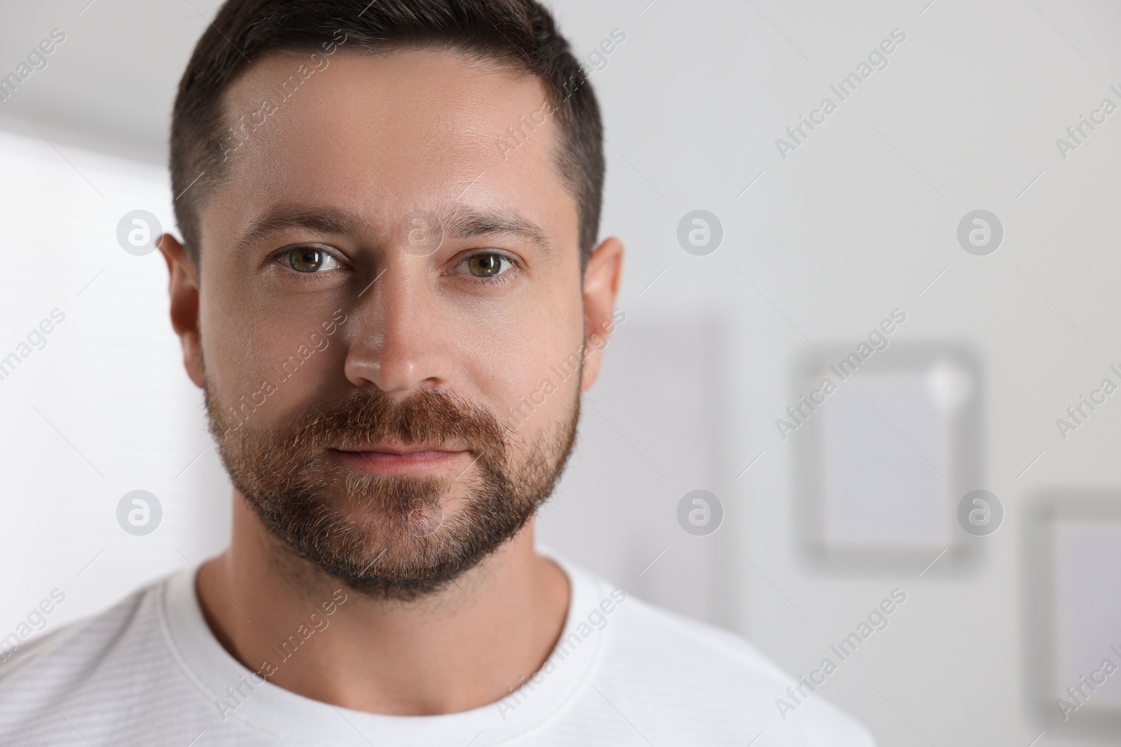 Photo of Portrait of handsome man on blurred background, space for text