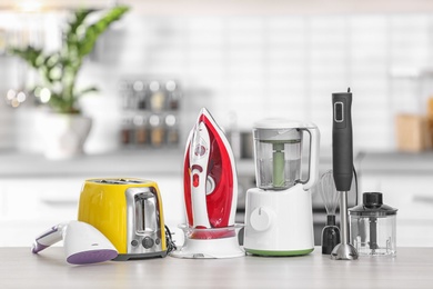 Photo of Household and kitchen appliances on table indoors. Interior element