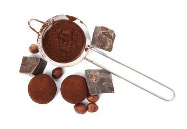 Photo of Delicious chocolate truffles with ingredients on white background, top view