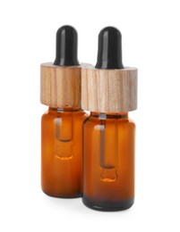 Photo of Bottles of essential oil on white background