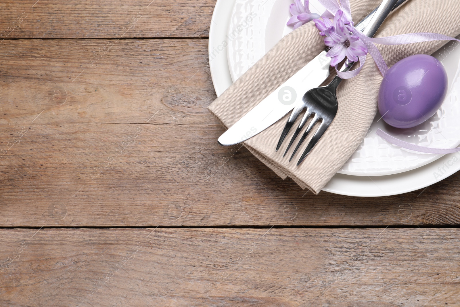 Photo of Festive Easter table setting with egg on wooden background, top view. Space for text