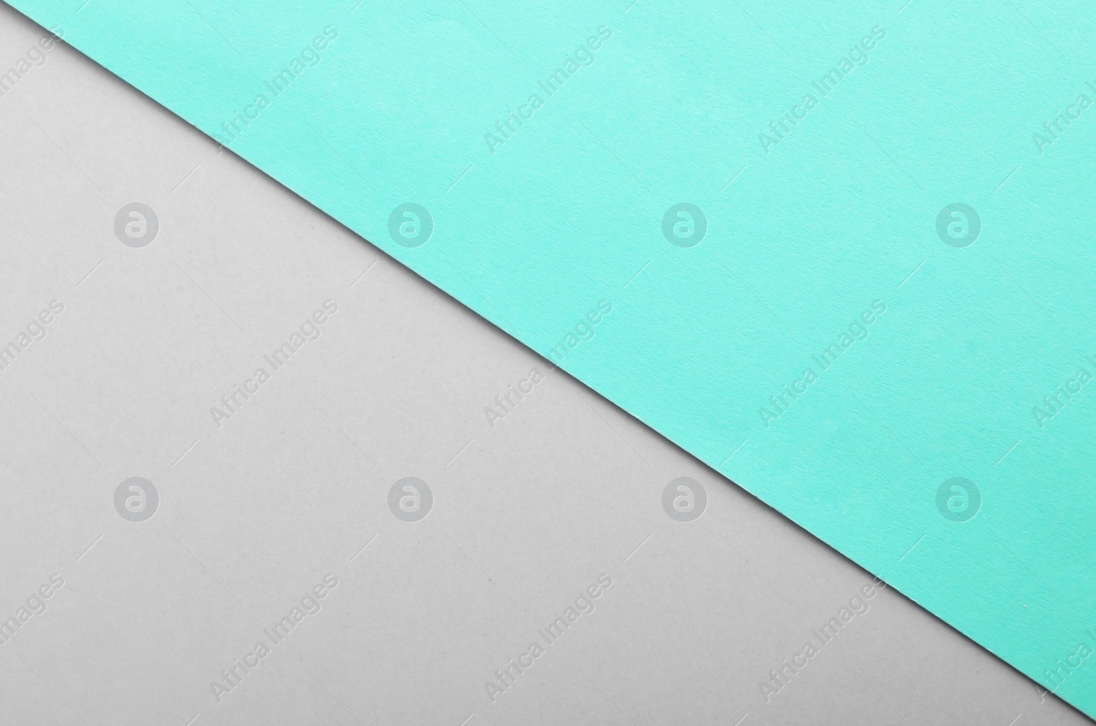 Photo of Turquoise and grey paper sheets as colorful background, top view