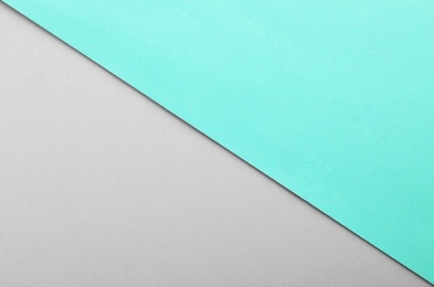 Photo of Turquoise and grey paper sheets as colorful background, top view