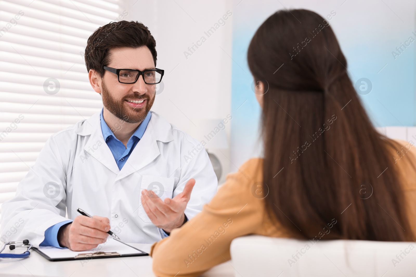 Photo of Doctor consulting patient during appointment in clinic