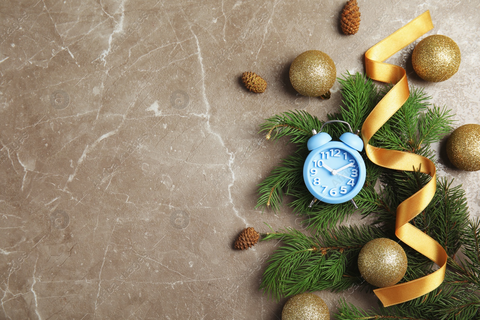 Photo of Flat lay composition with alarm clock, fir branches and decorations on grey background. Christmas countdown