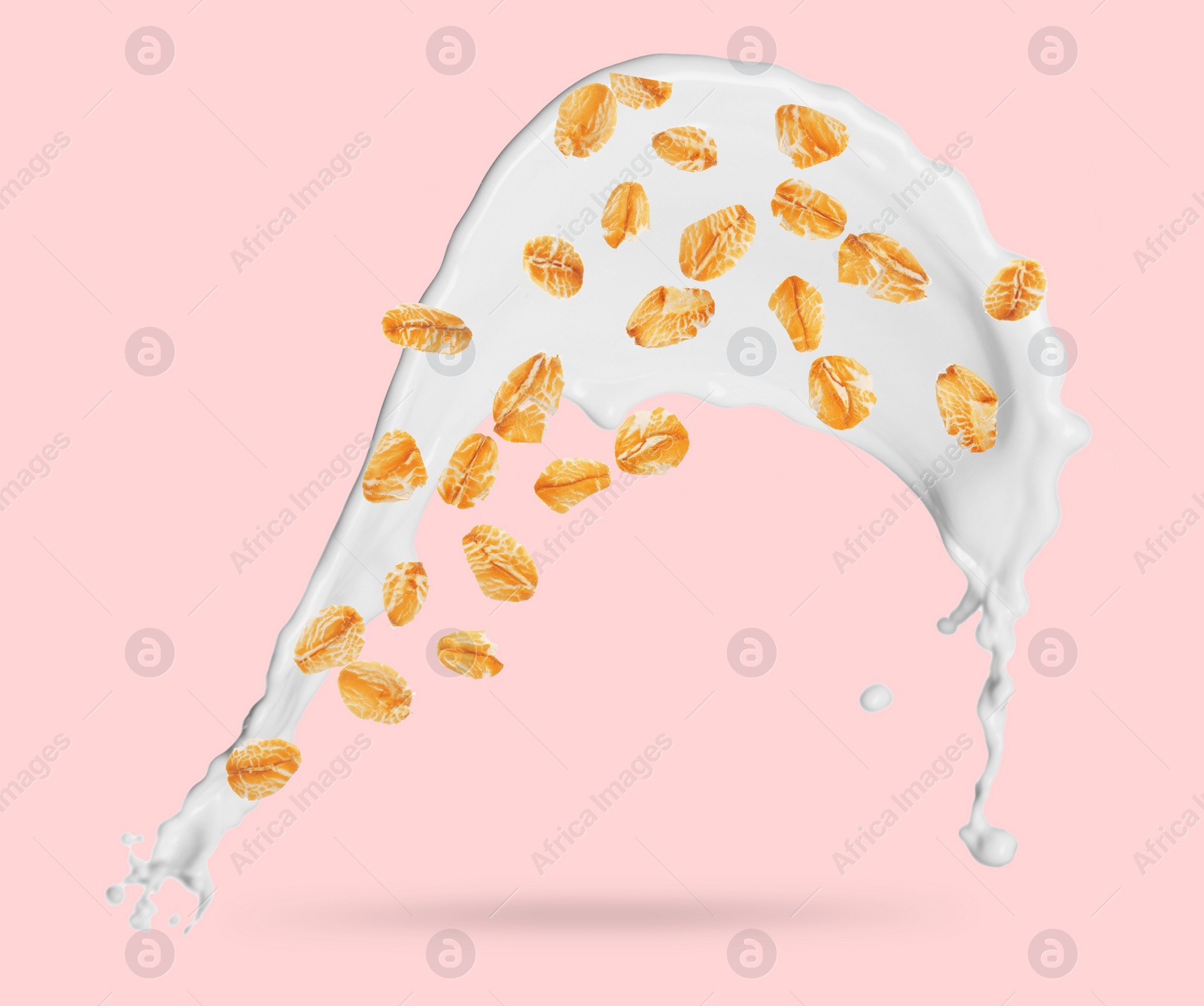 Image of Rolled oats and milk splash on pink background