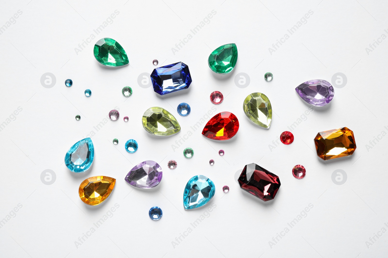 Photo of Different beautiful gemstones on white background, top view