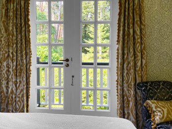 Photo of Window with beautiful view on garden in cozy room. Interior design