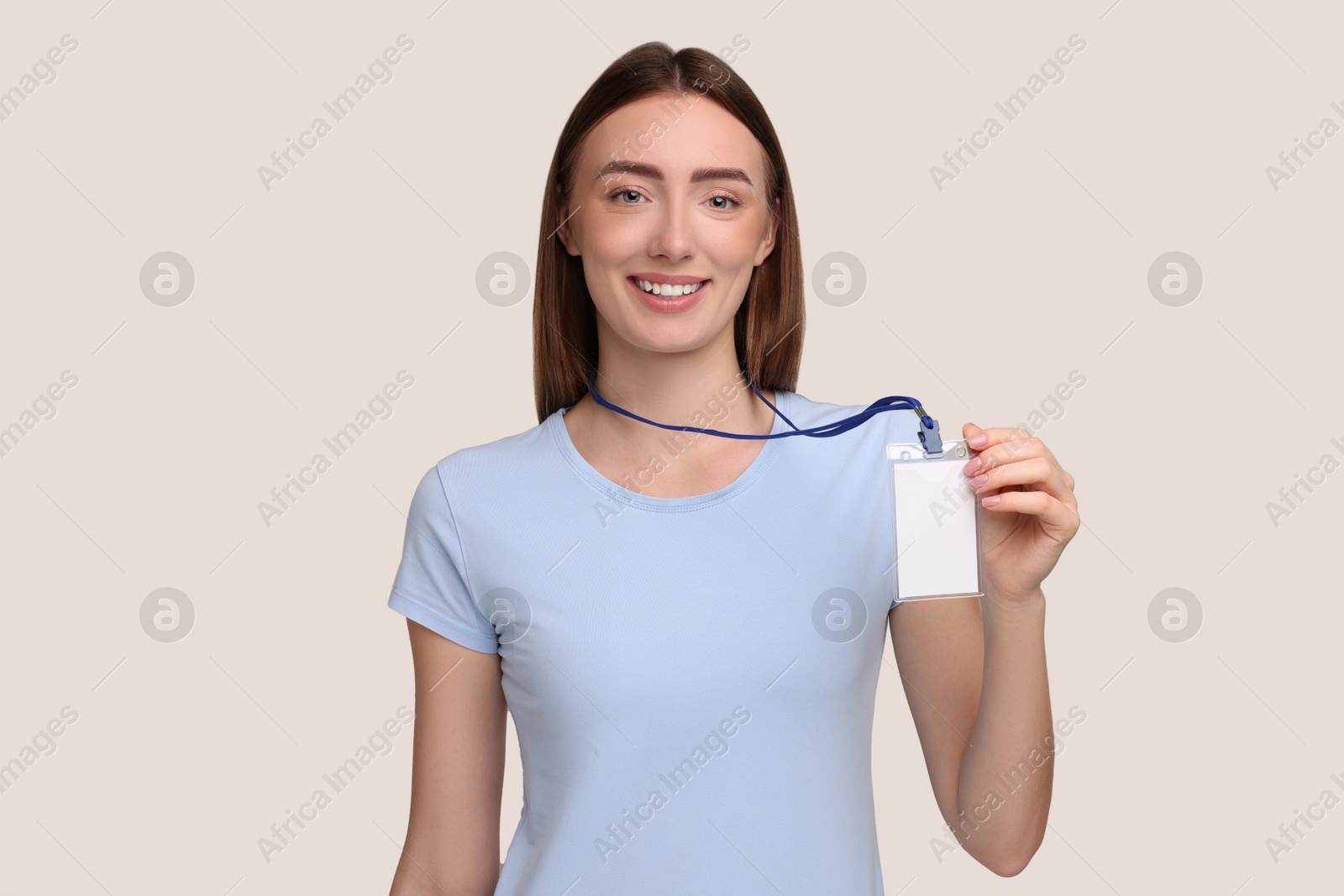 Photo of Woman with blank badge on grey background