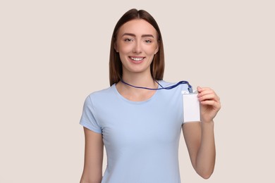 Photo of Woman with blank badge on grey background