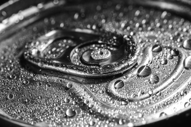 Aluminum can of beverage covered with water drops, closeup