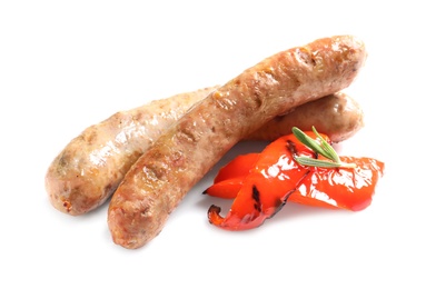 Delicious barbecued sausages and pepper on white background